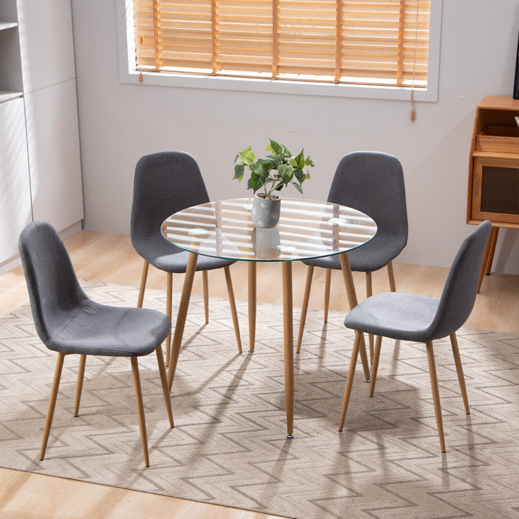 Small round glass best sale dining table and chairs